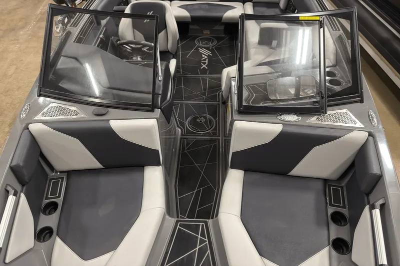 Slide: The Image of 2021 ATX Surf Boats 20 Type-S interior with gray and white seating, open windshield, and cup holders. - 17