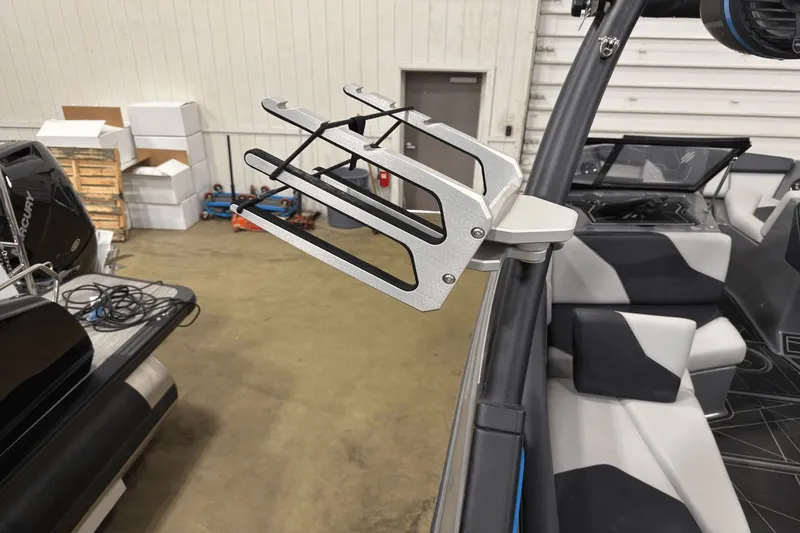 Slide: The Image of 2021 ATX Surf Boats 20 Type-S interior with wakeboard rack in a garage setting. - 22