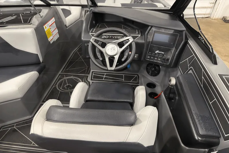 Slide: The Image of 2021 ATX Surf Boats 20 Type-S interior with steering wheel and dashboard controls. - 9