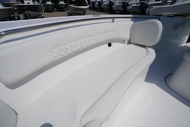 Slide: The Image of 2026 Tidewater 232 CC Adventure boat with white cushioned seating detail. - 10