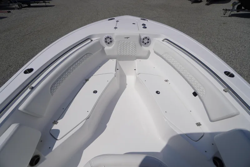 Slide: The Image of 2026 Tidewater 232 CC Adventure boat interior with white seating and storage compartments. - 15