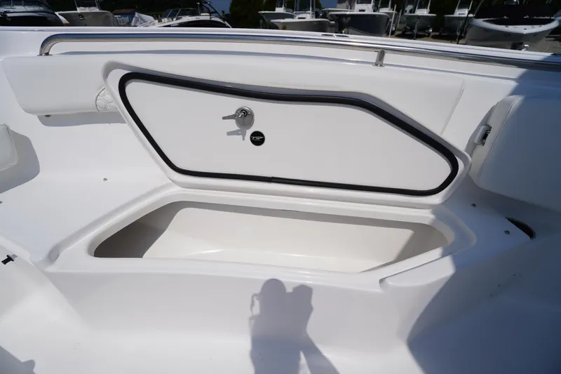 Slide: The Image of 2026 Tidewater 232 CC Adventure boat storage compartment open, showcasing interior space. - 18