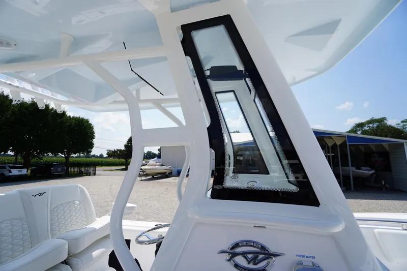 Slide: The Image of 2026 Tidewater 232 CC Adventure boat interior with seating and console details. - 26
