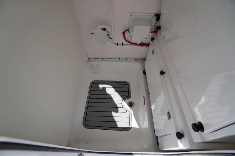 Slide: The Image of Interior of 2026 Tidewater 232 CC Adventure boat, featuring storage compartment and wiring. - 30