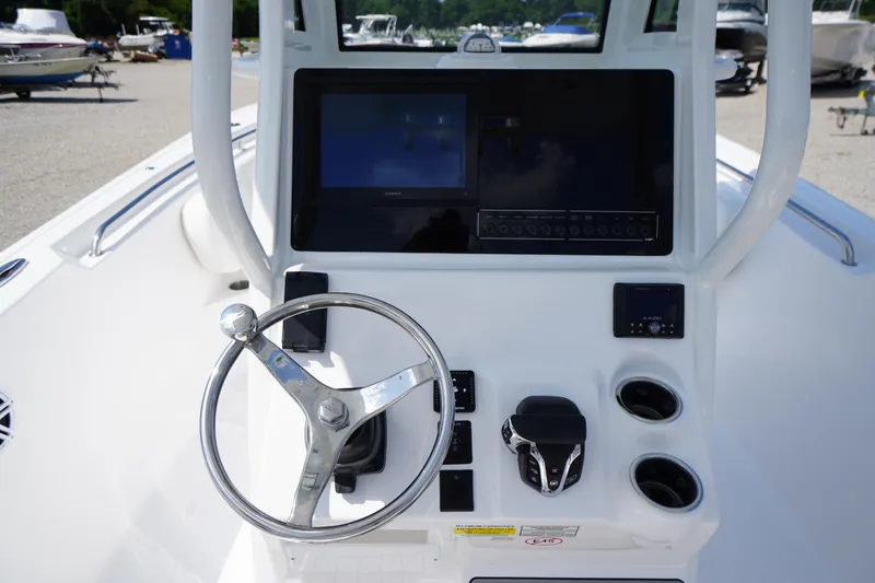 Slide: The Image of 2026 Tidewater 232 CC Adventure boat console with steering wheel and navigation display. - 34