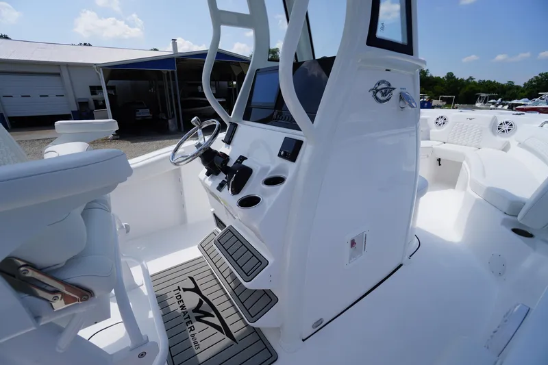 Slide: The Image of 2026 Tidewater 232 CC Adventure boat interior with helm, seating, and modern controls. - 43