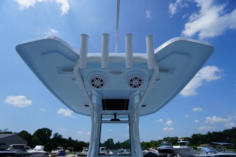 Slide: The Image of 2026 Tidewater 232 CC Adventure boat, featuring a sleek T-top with rod holders and speakers. - 44