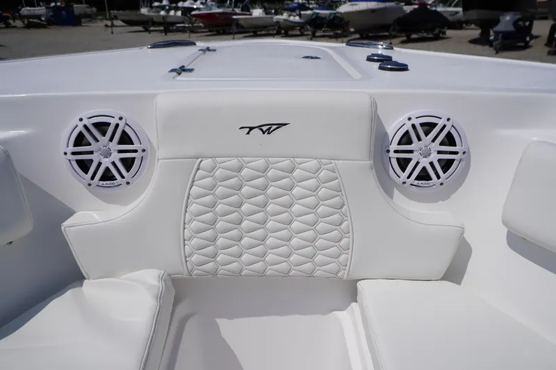 Slide: The Image of 2026 Tidewater 232 CC Adventure boat interior with white cushioned seating and JL Audio speakers. - 7