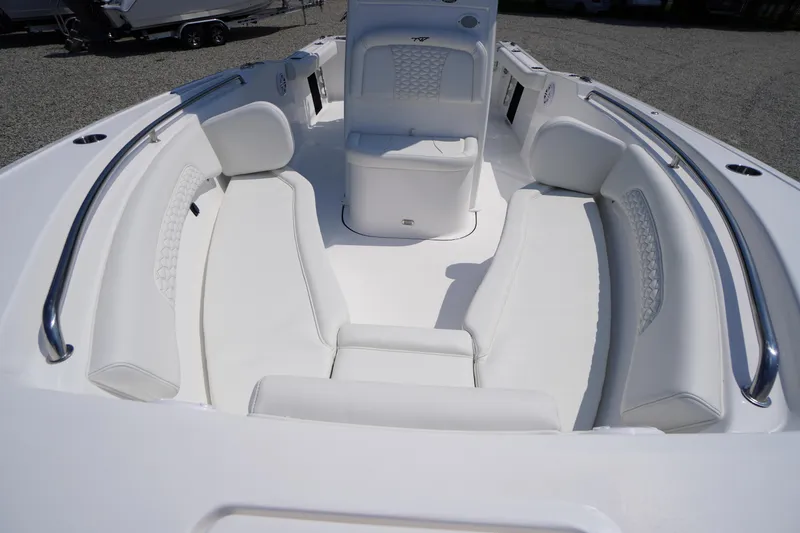 Slide: The Image of 2026 Tidewater 232 CC Adventure boat interior with white cushioned seating and stainless steel rails. - 9