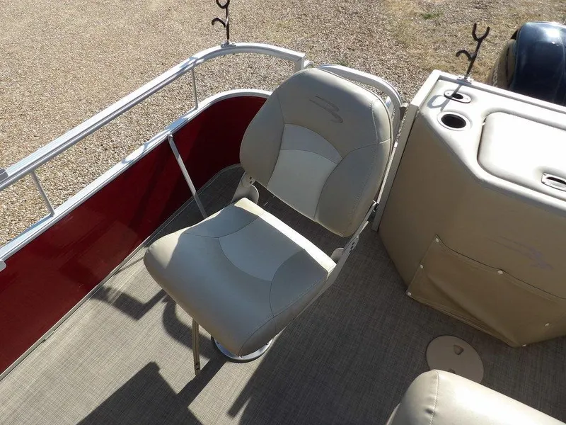 Slide: The Image of 2015 Bennington 20 SFX boat interior with beige seating and red railing. - 18
