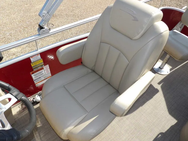 Slide: The Image of 2015 Bennington 20 SFX boat seat, beige leather, red paneling, steering wheel visible. - 19