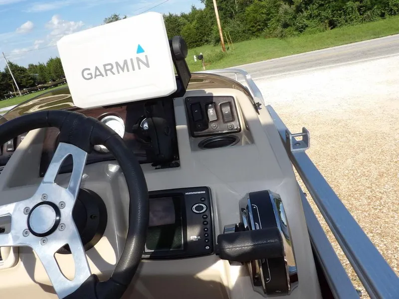 Slide: The Image of 2015 Bennington 20 SFX boat dashboard with Garmin navigation system and steering wheel. - 20