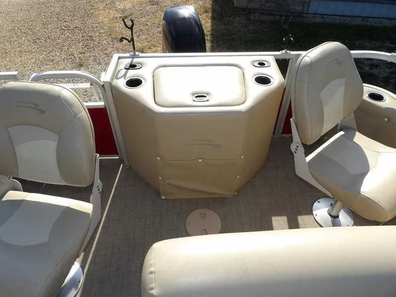 Slide: The Image of 2015 Bennington 20 SFX boat interior with beige seating and fishing rod holders. - 24