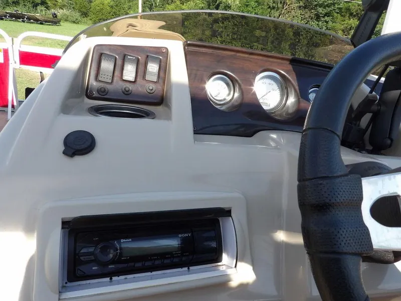 Slide: The Image of 2015 Bennington 20 SFX boat dashboard with controls and steering wheel. - 25