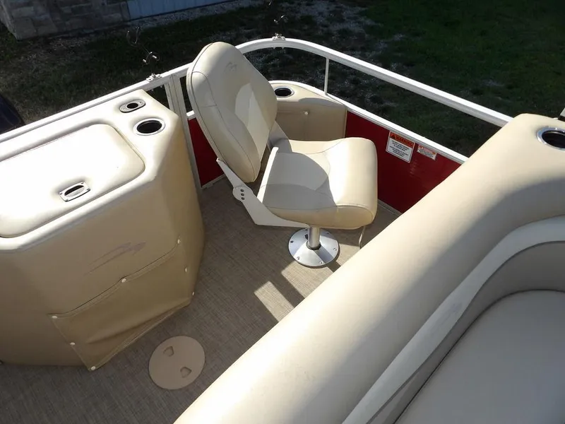 Slide: The Image of 2015 Bennington 20 SFX boat interior with beige seating and storage compartments. - 26