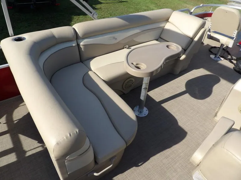 Slide: The Image of 2015 Bennington 20 SFX boat interior with beige seating and table, ideal for leisure. - 27