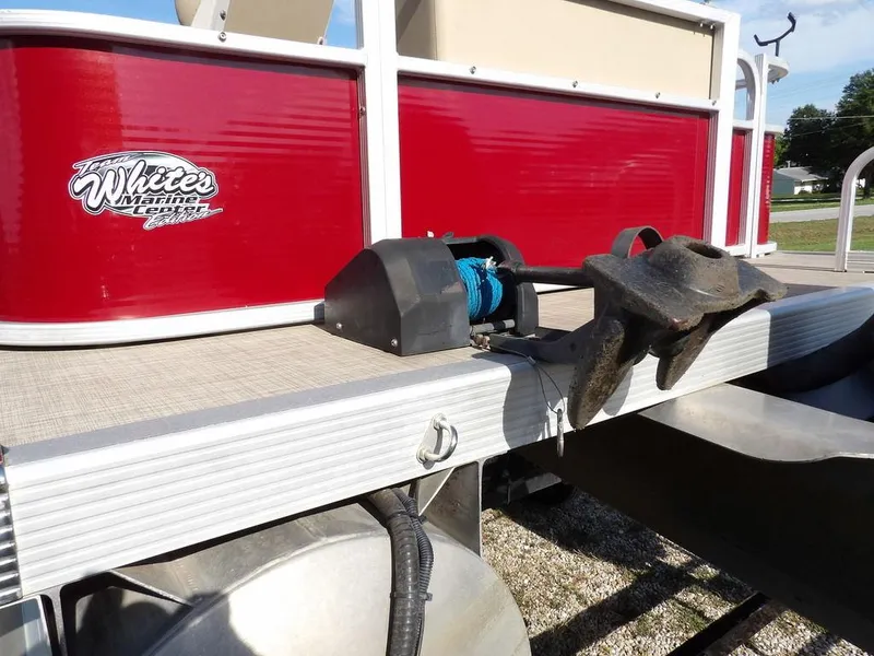 Slide: The Image of 2015 Bennington 20 SFX pontoon boat with anchor, red exterior, and White's Marine Center logo. - 30