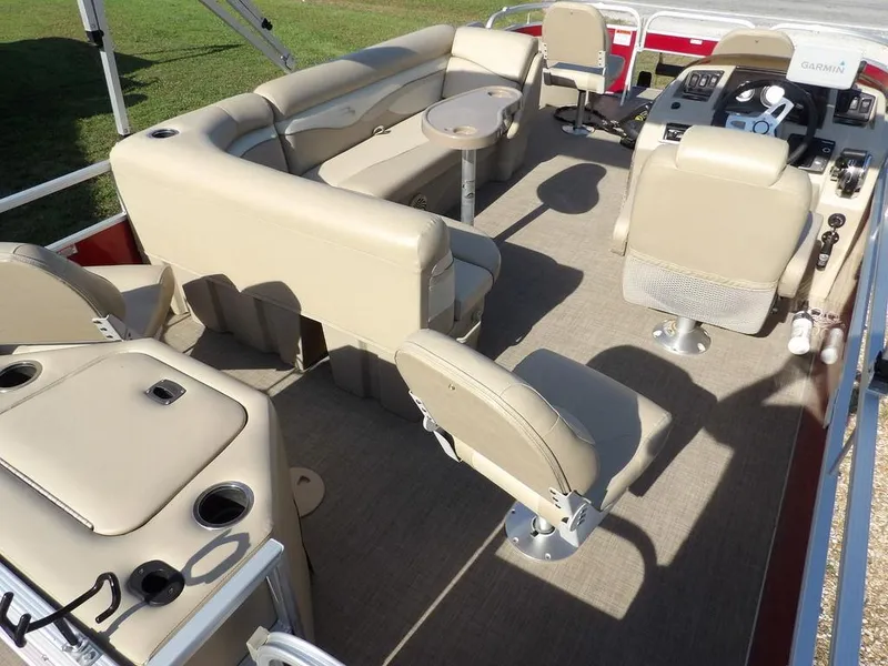 Slide: The Image of 2015 Bennington 20 SFX pontoon boat interior with beige seating and steering console. - 33
