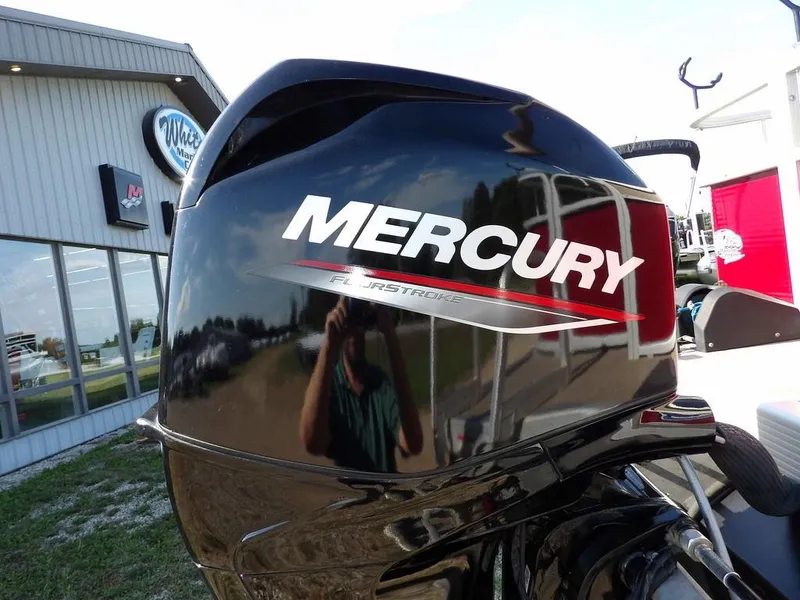 Slide: The Image of Mercury FourStroke engine on a 2015 Bennington 20 SFX boat, outdoor dealership setting. - 36