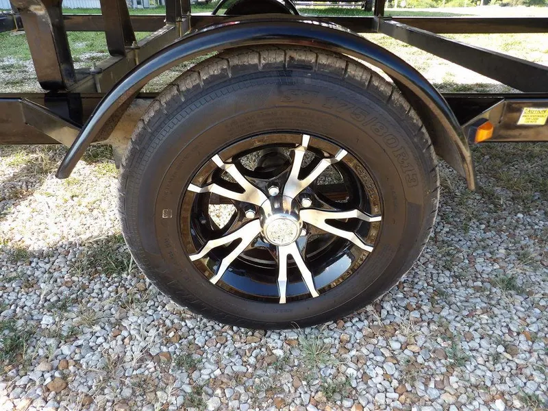 Slide: The Image of 2015 Bennington 20 SFX trailer wheel on gravel surface. - 37