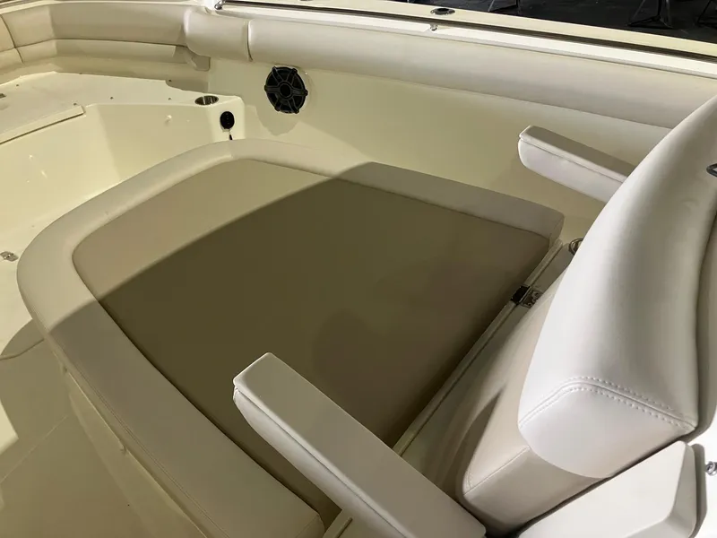 Slide: The Image of 2025 Boston Whaler 330 Outrage boat interior with cushioned seating and armrests. - 16