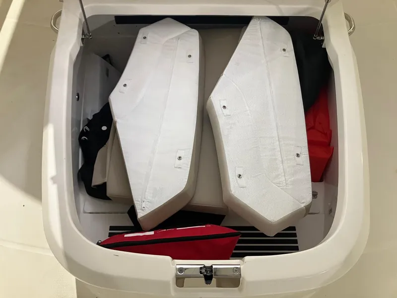 Slide: The Image of Storage compartment of 2025 Boston Whaler 330 Outrage boat with cushions and gear. - 17