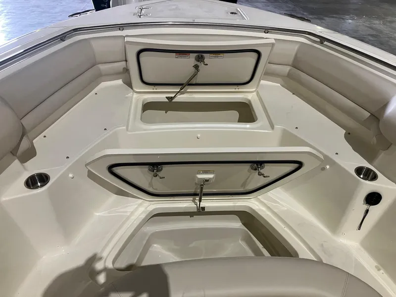 Slide: The Image of 2025 Boston Whaler 330 Outrage boat interior with storage compartments and seating. - 18