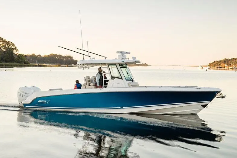Slide: The Image of Manufacturer Provided Image: 2025 Boston Whaler 330 Outrage cruising on calm water at sunset. - 28