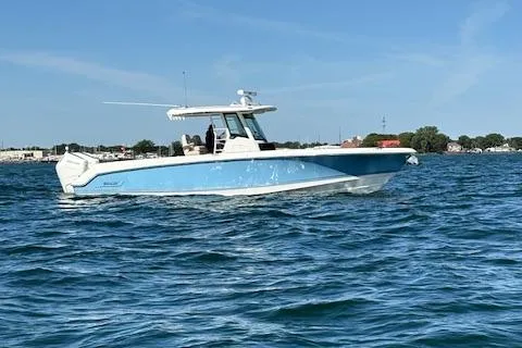 Slide: The Image of 2025 Boston Whaler 330 Outrage boat cruising on a sunny day. - 36