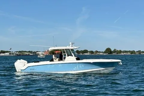 Slide: The Image of 2025 Boston Whaler 330 Outrage boat cruising on a sunny day. - 37