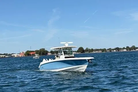 Slide: The Image of 2025 Boston Whaler 330 Outrage boat cruising on a sunny day. - 38
