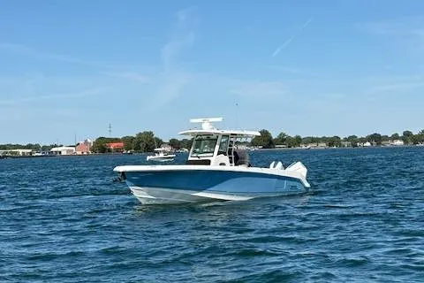 Slide: The Image of 2025 Boston Whaler 330 Outrage boat cruising on a sunny day. - 40