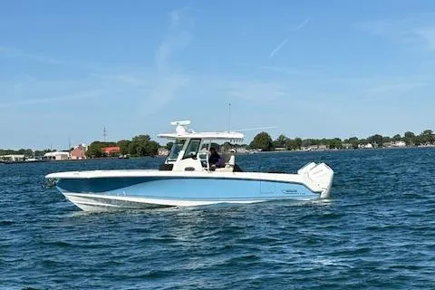 Slide: The Image of 2025 Boston Whaler 330 Outrage boat cruising on a sunny day in open water. - 41