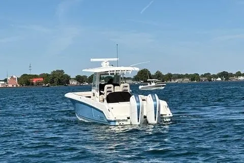 Slide: The Image of 2025 Boston Whaler 330 Outrage boat cruising on a sunny day. - 45