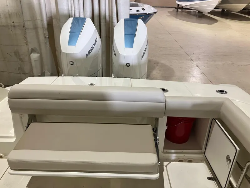 Slide: The Image of 2025 Boston Whaler 330 Outrage boat with dual Mercury engines and cushioned seating. - 6