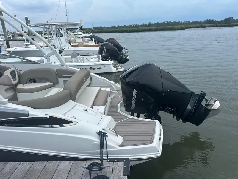 Slide: The Image of 2023 Crownline Eclipse E235 XS boat docked with Mercury outboard engine. - 4