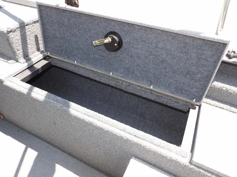 Slide: The Image of Open storage compartment in 2022 G3 Angler V164 F boat, featuring carpeted interior. - 15