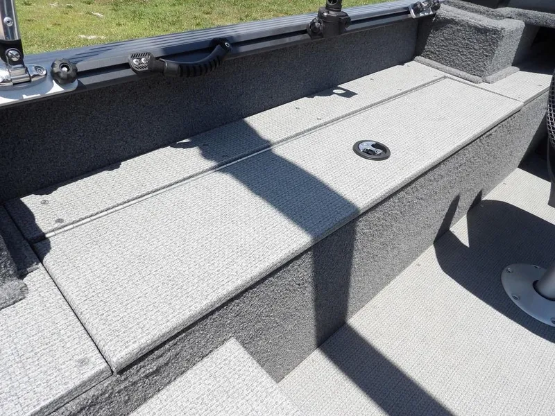 Slide: The Image of 2022 G3 Angler V164 F boat interior with gray textured flooring and storage compartment. - 17