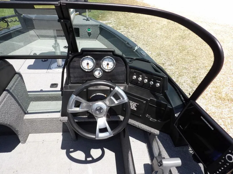 Slide: The Image of 2022 G3 Angler V164 F boat dashboard with steering wheel and control panel. - 18