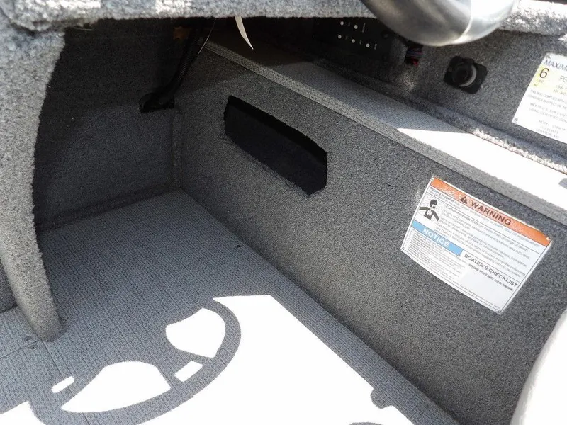 Slide: The Image of Interior of 2022 G3 Angler V164 F boat showing storage compartment and safety warnings. - 26