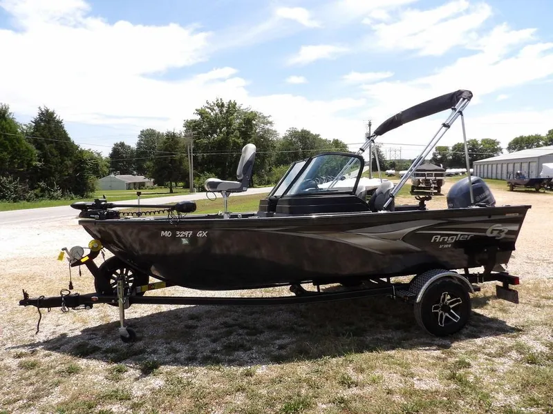 Slide: The Image of 2022 G3 Angler V164 F fishing boat on trailer, parked outdoors under a clear sky. - 3