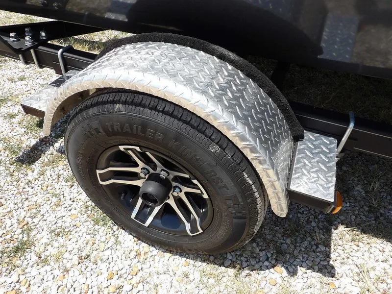 Slide: The Image of 2022 G3 Angler V164 F trailer wheel with diamond plate fender on gravel surface. - 43