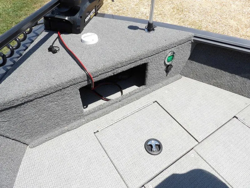 Slide: The Image of 2022 G3 Angler V164 F boat interior with carpeted deck and storage compartments. - 44