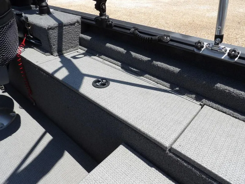 Slide: The Image of Interior of 2022 G3 Angler V164 F boat, featuring carpeted storage and seating area. - 6