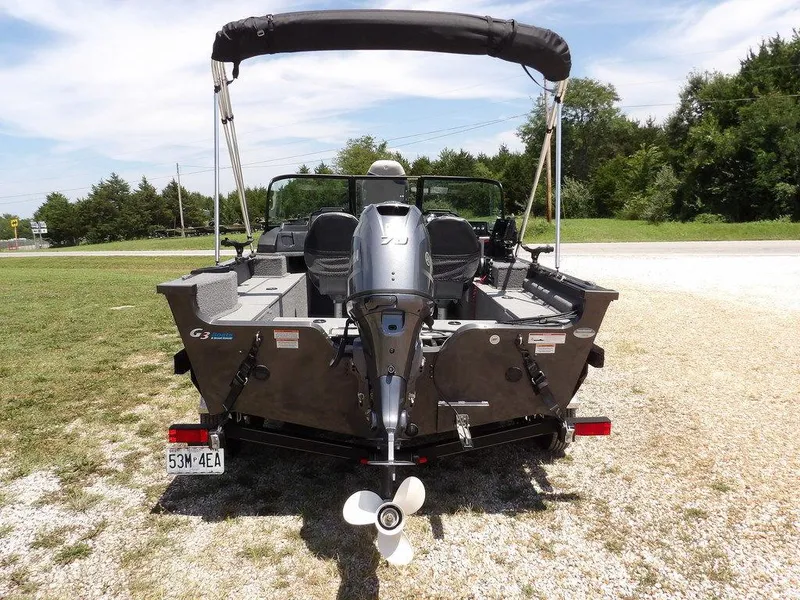 Slide: The Image of 2022 G3 Angler V164 F boat with outboard motor, parked on gravel. - 8