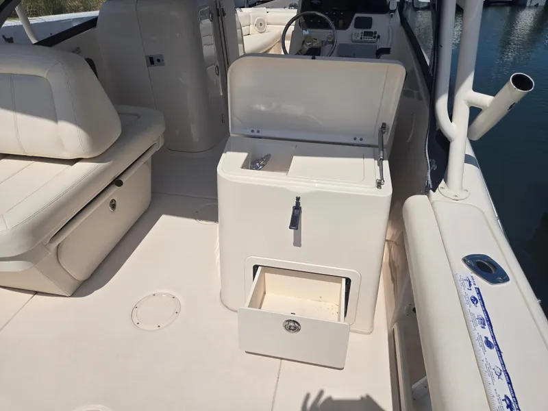 Slide: The Image of 2016 Grady-White Freedom 255 boat interior with seating and storage compartments. - 12
