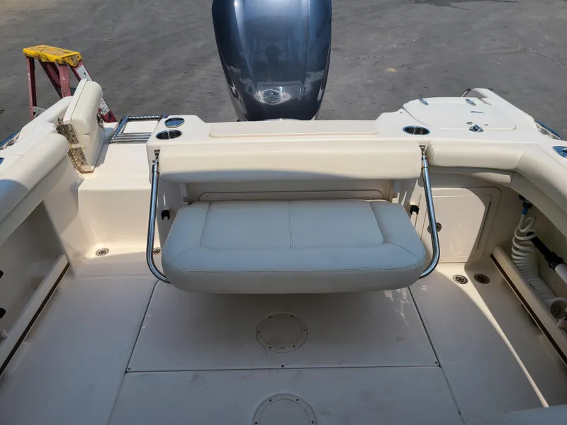 Slide: The Image of 2016 Grady-White Freedom 255 boat interior with foldable seat and motor. - 15
