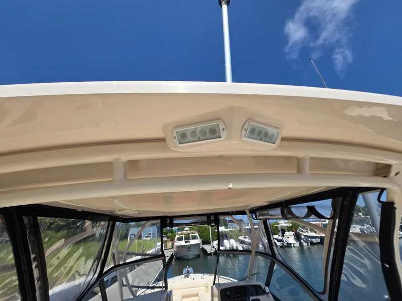 Slide: The Image of 2016 Grady-White Freedom 255 boat interior with clear sky and marina view. - 9