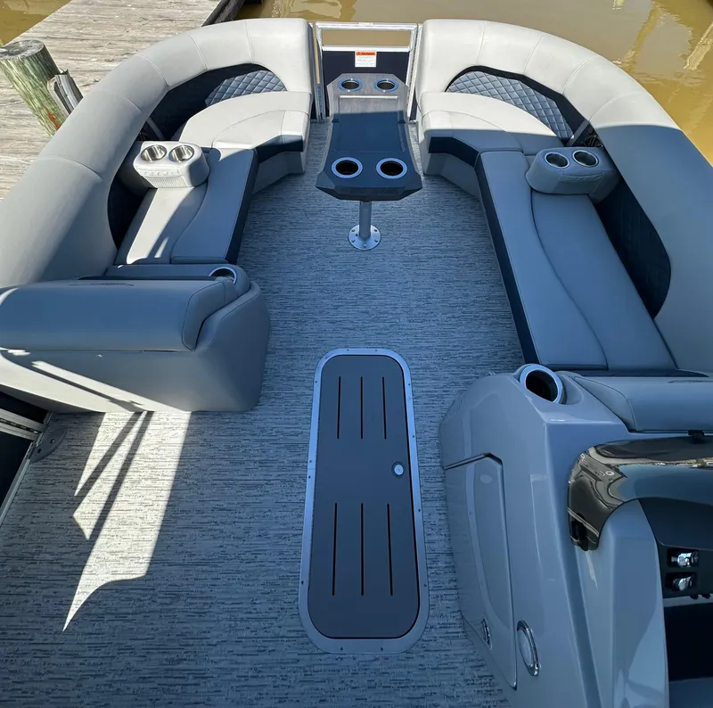 Slide: The Image of 2025 Bennington 23LFB pontoon boat interior with gray seating and cup holders. - 11
