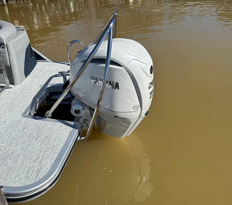 Slide: The Image of 2025 Bennington 23LFB boat with Yamaha outboard motor on calm water. - 12